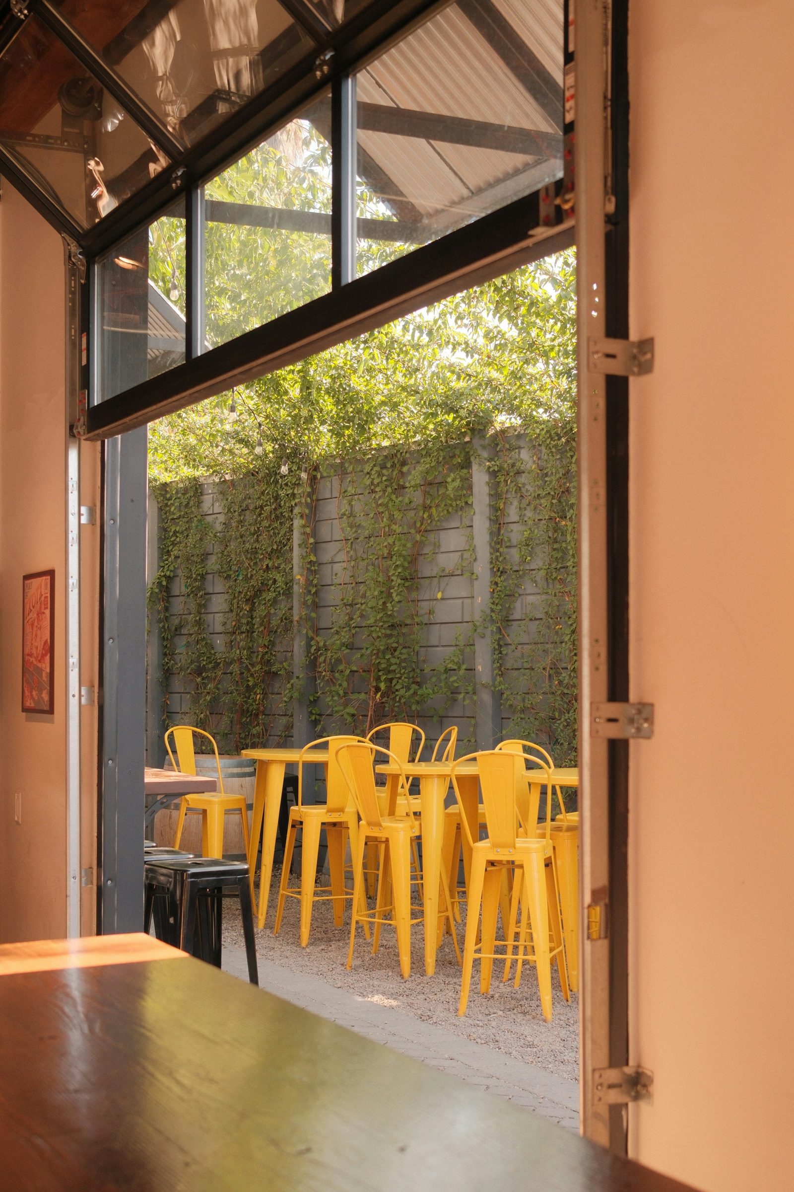 Door opened onto a sunlit courtyard terrace