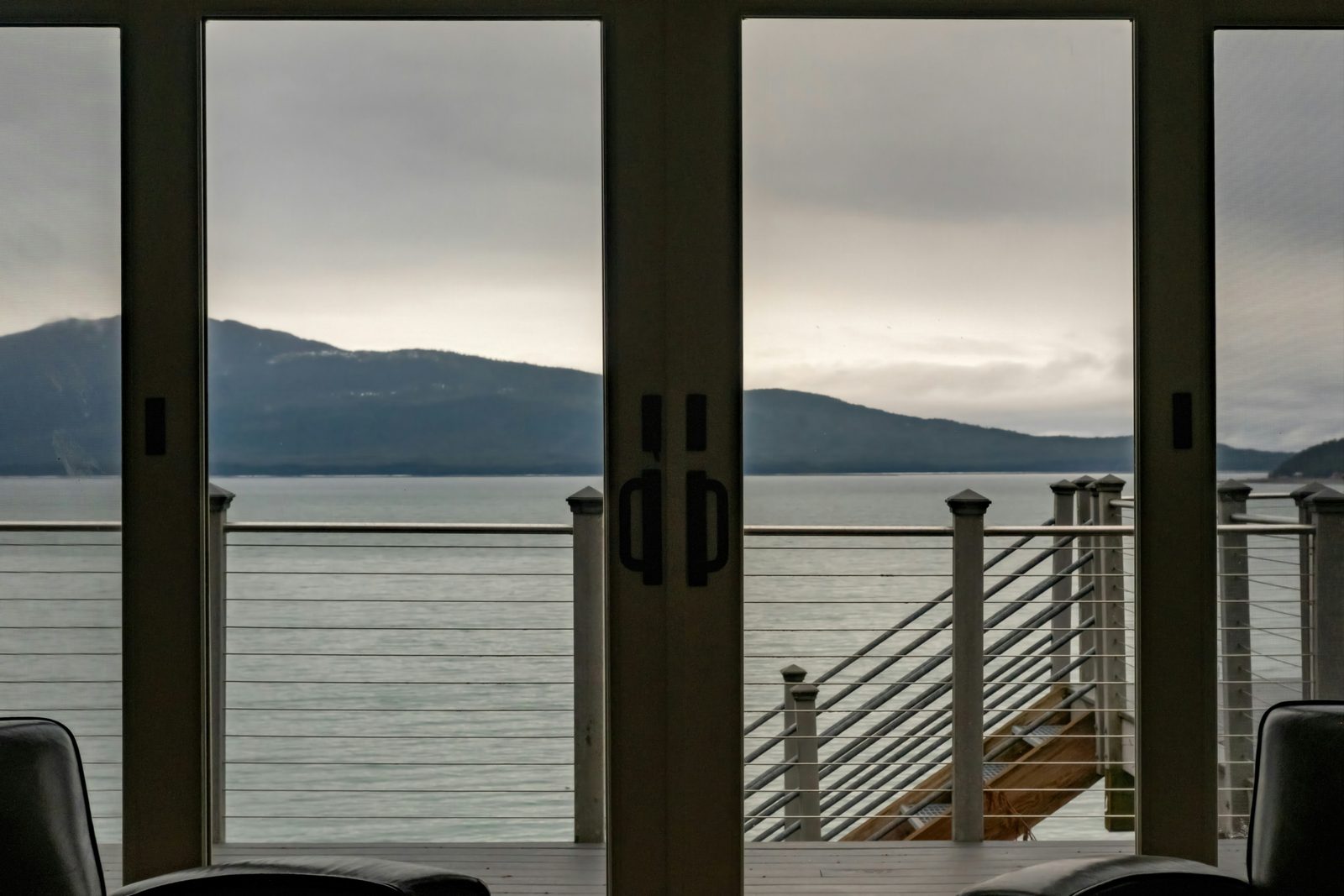 Patio doors opening to a sea and mountain view