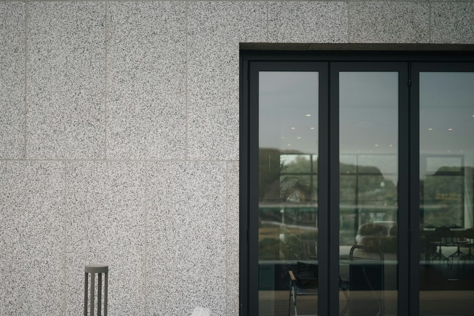 Aluminum sliding patio doors on a stone-clad elevation